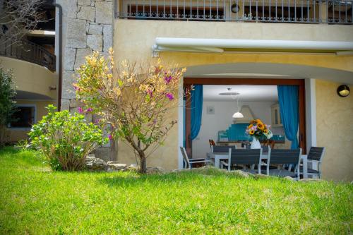 a house with a patio with a table and chairs at Villa Isuledda Prestige in San Teodoro