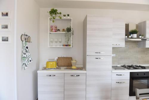 a kitchen with white cabinets and a counter top at Fornillo 41 in Poggiomarino