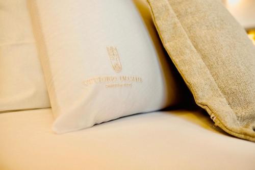 a book sitting on top of a bed at Vittorio Emanuele Charming Suites in Monopoli