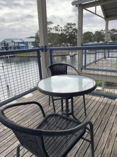 a table and two chairs sitting on a deck at The View - Captains Cove Waterfront Resort in Paynesville