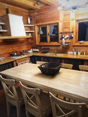 a wooden kitchen with a wooden table and chairs at Dom Suwalszczyzna in Suwałki