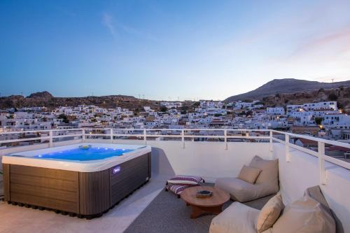 a hot tub on the roof of a house at Heritage Luxury Suites in Líndos