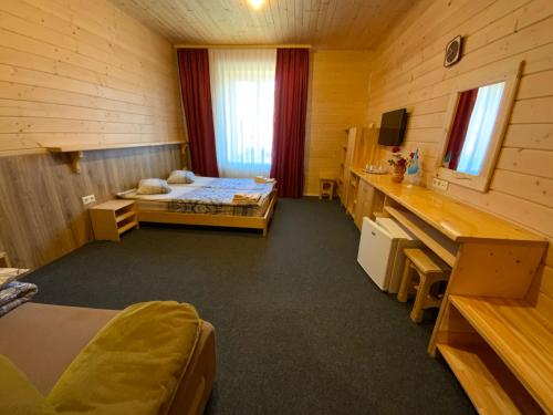 a room with two beds and a television in it at Туристичний комплекс ВОРОХТА 365 Turistichesky Kompleks Vorokhta 365 in Vorokhta