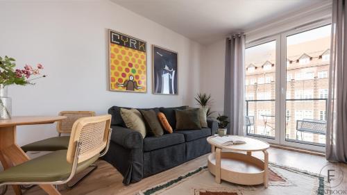 a living room with a couch and a table at Flatbook - City Center Apartments Aura 40 in Gdańsk