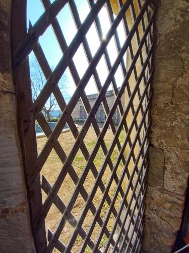 a window with a fence looking out at a field at Château de Fabiargues in Saint-Ambroix