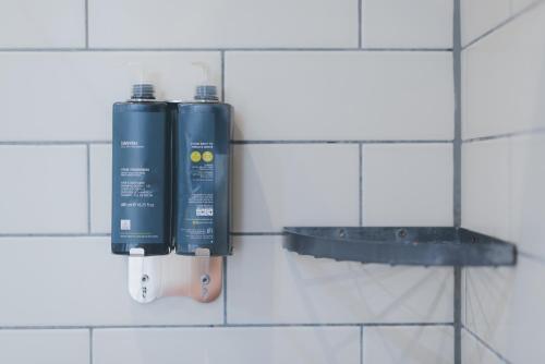 two blue batteries are hanging on a tiled wall at Florence House Boutique Hotel and Restaurant in Portsmouth