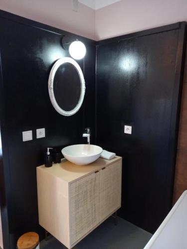 a bathroom with a sink and a mirror on the wall at Château de Fabiargues in Saint-Ambroix