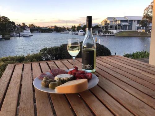 a plate of food and a glass of wine on a table at The View - Captains Cove Waterfront Resort in Paynesville