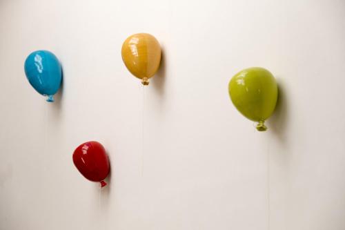 a group of balloons hanging on a wall at Amatè Suite in Lecce