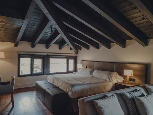a bedroom with a bed and a couch at Santa María Briones in Briones