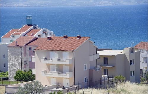 a group of buildings next to the ocean at Lovely Apartment In Podstrana in Podstrana