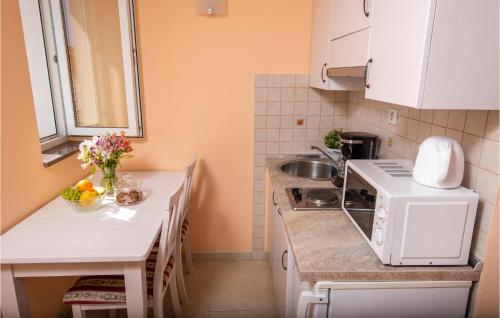 a small kitchen with a sink and a microwave at Lovely Apartment In Podstrana in Podstrana