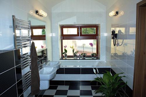 a bathroom with a toilet and a sink and a window at Apartmany BB in Karviná