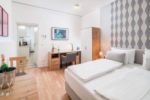 a white bedroom with a bed and a desk at Best Western Plus Celebrity Suites in Vienna
