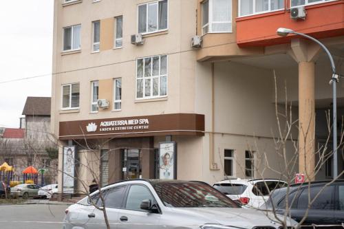 a white car parked in front of a building at RentWill apartments Panoramic View in Chişinău
