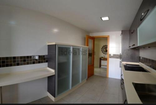 a large kitchen with stainless steel cabinets and appliances at Magnífico apartamento en El Pto de Sta María, aire acc, piscina, zona niños y padel in El Puerto de Santa María