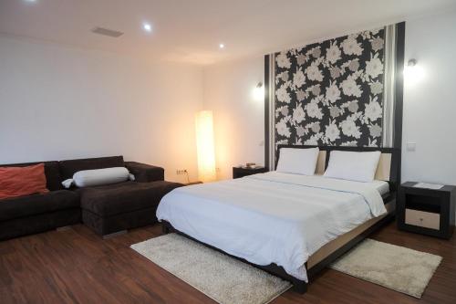 - une chambre avec un grand lit et un canapé dans l'établissement Apartament curat si confortabil in centru Str. Armeneasca 47, à Chişinău