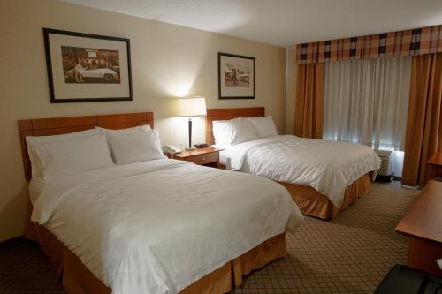 a hotel room with two beds and a window at Holiday Inn Battle Creek by IHG in Battle Creek