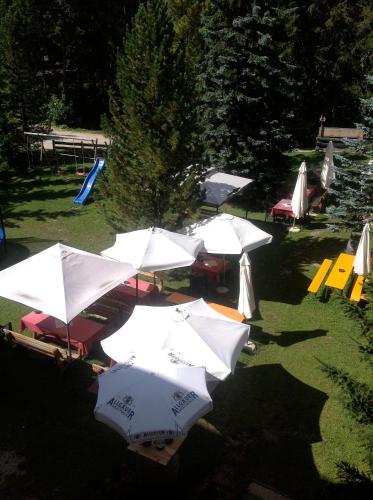 a group of white umbrellas in a park at Residence Salvan in Corvara in Badia
