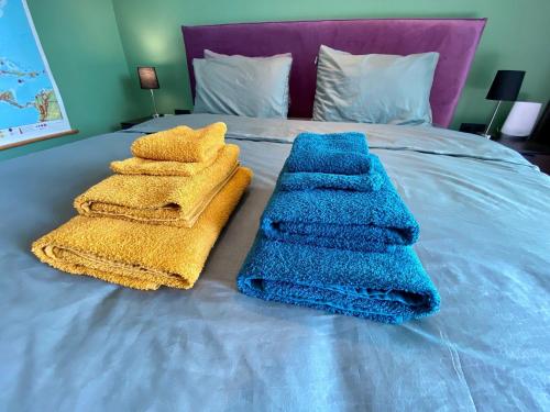 a bed with blue towels on top of it at FinIQ Boutiq Studios in Foiníki