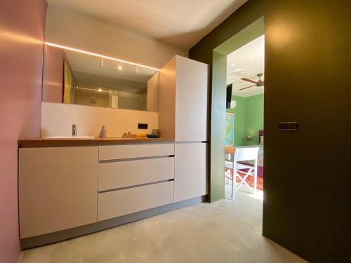 a kitchen with a sink and a counter top at FinIQ Boutiq Studios + Apartment in Foiníki