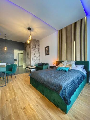 a bedroom with a large bed and a living room at Apartament czarny z jacuzzi in Krakow