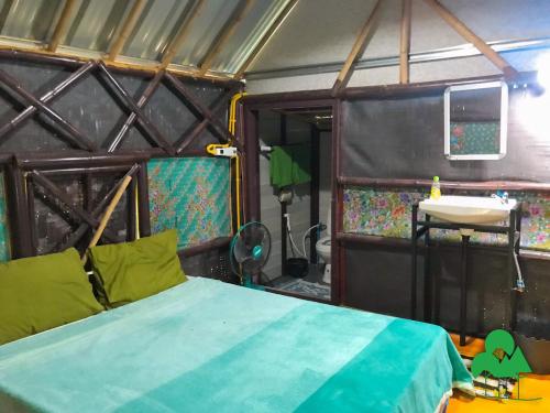 a bedroom with a bed and a sink in a room at Baan Suanthip Homestay - Aoluek Natural Retreat in Ao Luk