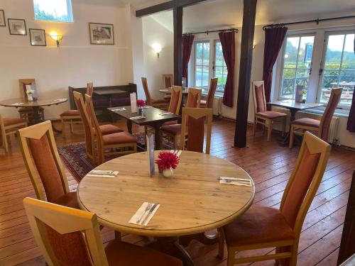 a restaurant with a wooden table and chairs at The Trooper Inn in Petersfield