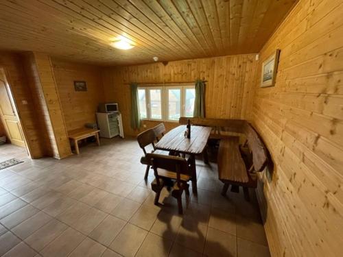 a wooden room with a wooden table and chairs at Inovecká Chata in Trenčianske Jastrabie