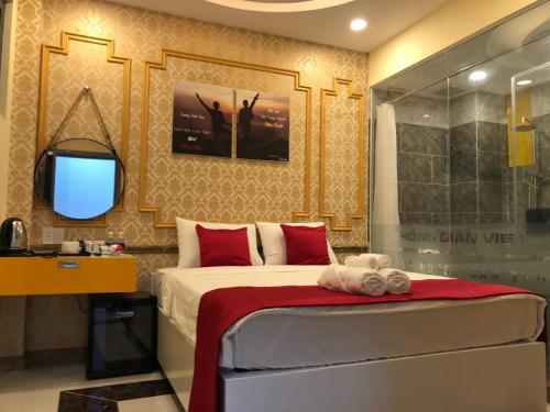 a bedroom with a bed and a tv and a shower at Soda House Cần Thơ in Can Tho