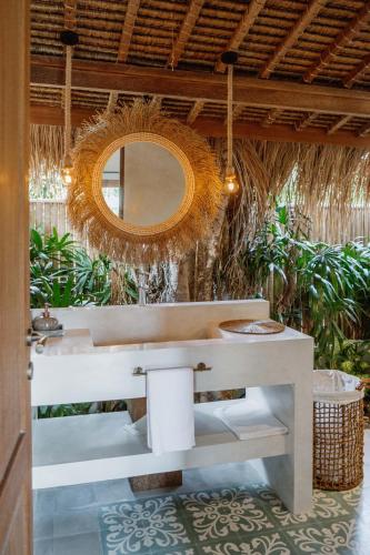 a bathroom with a sink and a mirror at Gypsea Bali in Uluwatu