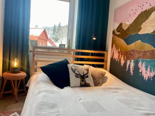 a bedroom with a bed with a large window at mieszkanko_karkonoska in Jelenia Góra