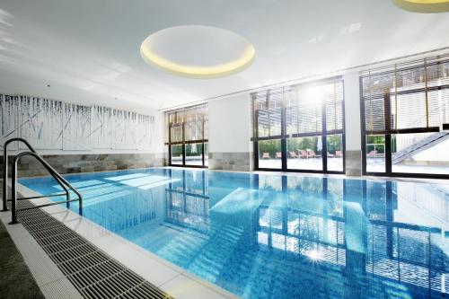 a large swimming pool in a building at Hotel Esplanade Resort & Spa - Adults Only in Bad Saarow