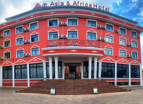 a red building with a staircase in front of it at Asia & Africa Hôtel in Antananarivo