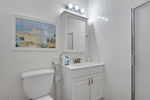 a white bathroom with a toilet and a sink at Gulf Crest #7 in Destin