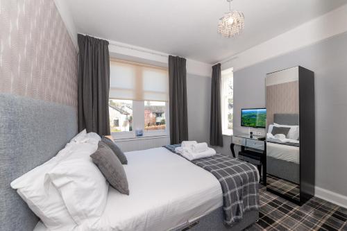 a hotel room with a bed and a television at The Coppice - including off-site health club in Windermere