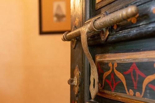 an old wooden door with a painting on it at Le Riad Villa Blanche in Agadir