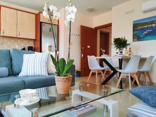 a living room with a blue couch and a table at Blue Lagoon Luxury Apartment A2 in Argostoli