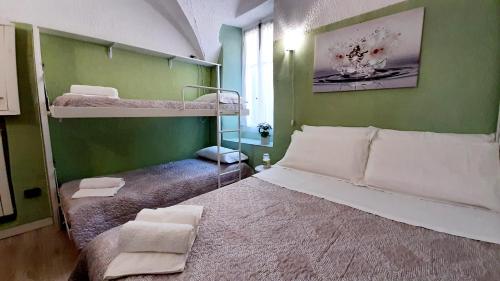 1 Schlafzimmer mit 2 Etagenbetten in einer grünen Wand in der Unterkunft Casa Ninnì Sanremo in Sanremo