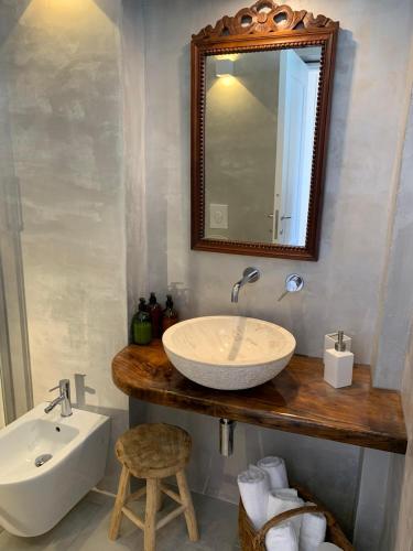 a bathroom with a sink and a mirror at Dimora delle Tonnare in Favignana