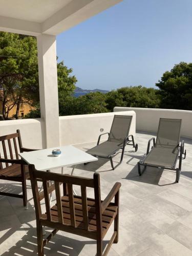 a patio with two chairs and a table and chairs at Dimora delle Tonnare in Favignana