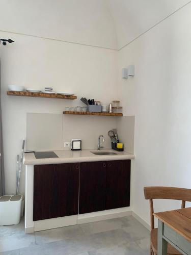 a kitchen with a sink and a counter top at Dimora delle Tonnare in Favignana