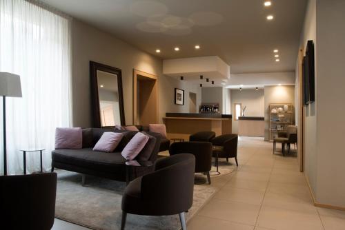 a living room with a couch and chairs at Albergo Nicolin in Lecco