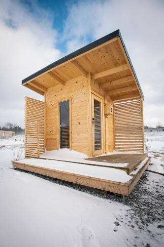 a wooden cabin with snow on the ground at Panorama Kořenec in Kořenec