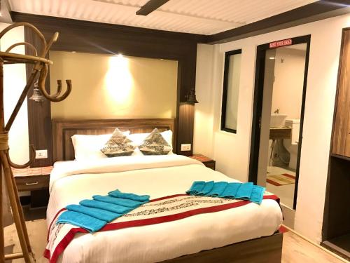 a bedroom with two beds with blue towels on it at Shiva Guest House in Bhaktapur