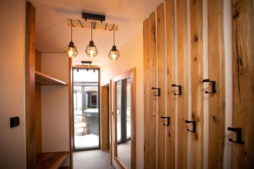 a hallway with wooden walls and lights in a house at Panorama Kořenec in Kořenec