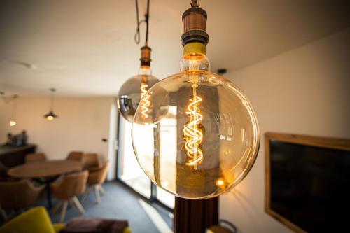 a glass light bulb hanging from a ceiling at Panorama Kořenec in Kořenec