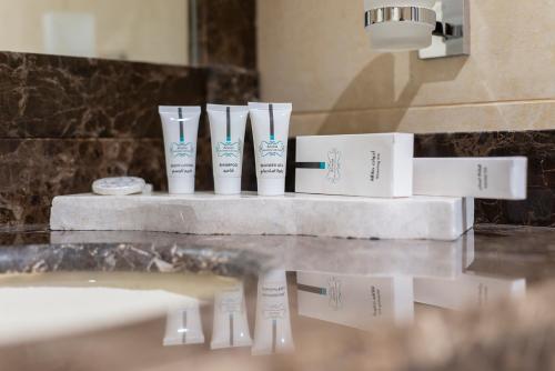 a group of toothbrushes on a counter in a bathroom at Enala Hotel - Tabuk in Tabuk