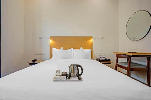 a hotel room with a bed with a coffee maker on it at UPAR Hotels - T Nagar in Chennai
