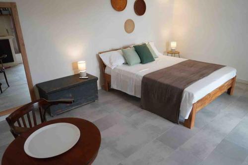 a bedroom with a bed and a table and a chair at Dimora delle Tonnare in Favignana